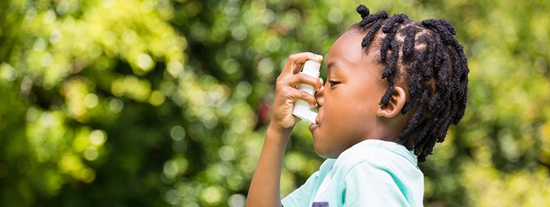 Boy using an asthma inhaler