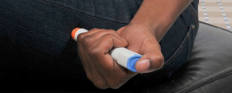 Woman injecting emergency medicine into her leg