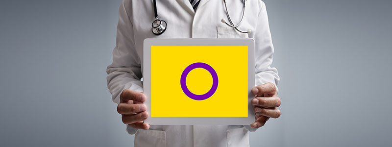 Doctor holding iPad with Intersex flag