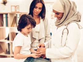 Doctor pricking child's finger