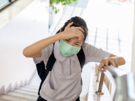 Girl experiencing dizziness while walking up the stairs.